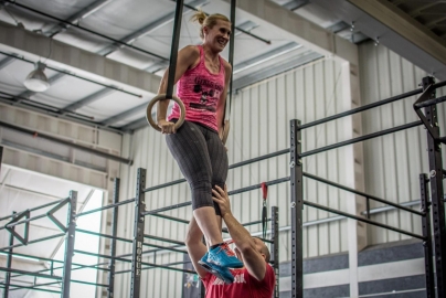 athlete on the rings mastering the muscle-up with personal gymnastics training at your local box